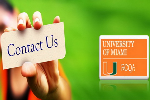 hand holding contact us sign with um logo in background